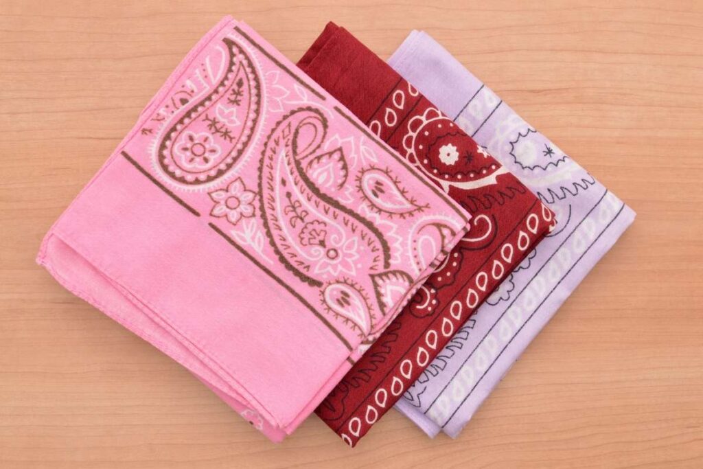 Three different colored custom printed bandanas kept with each other