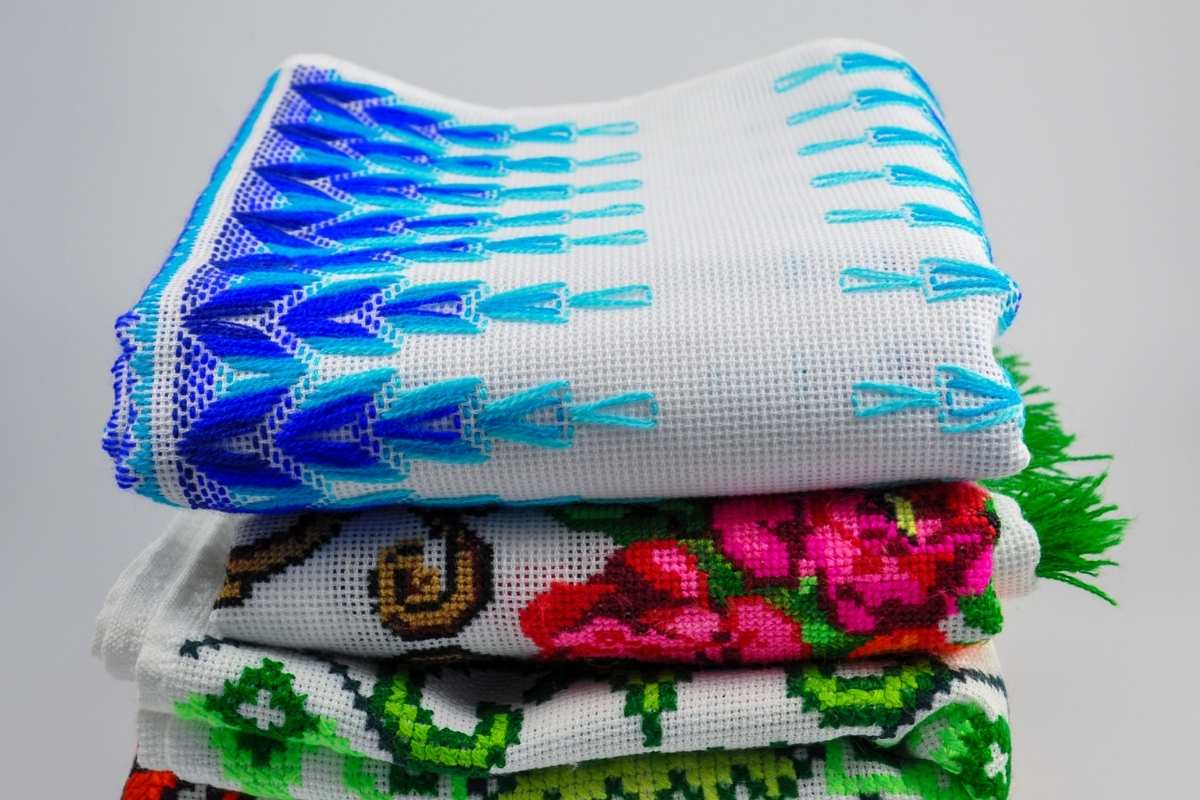Various embroidered hand towels neatly placed on top of each other