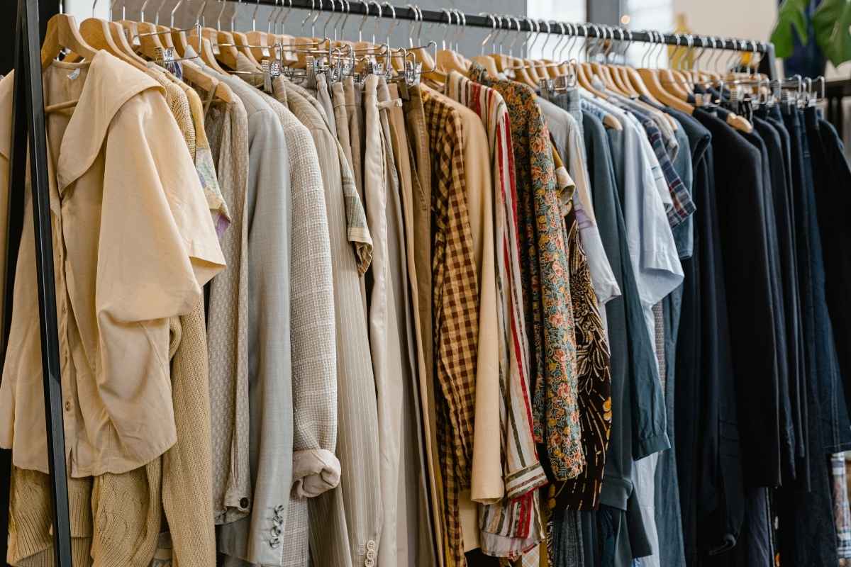 A collection of clothes labeled as sustainable but containing artificial materials.