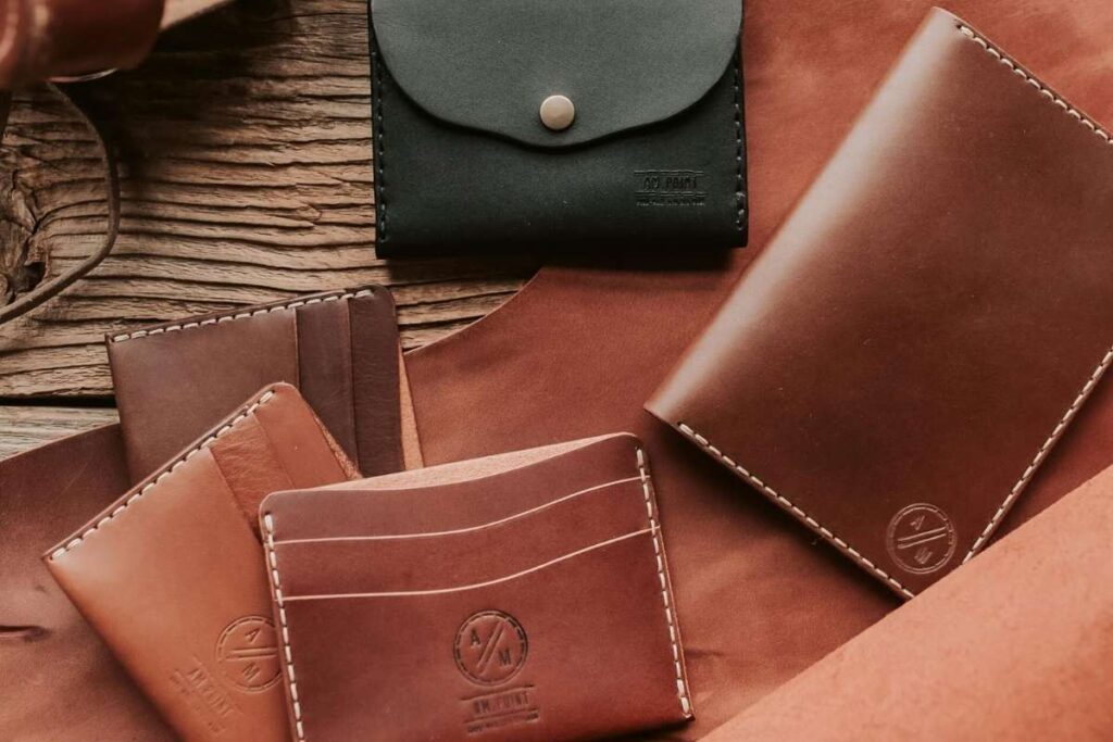 A collection of different custom men's leather wallets is shown in the image