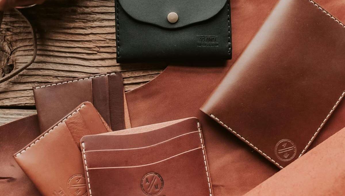 A collection of different custom men's leather wallets is shown in the image