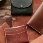 A collection of different custom men's leather wallets is shown in the image