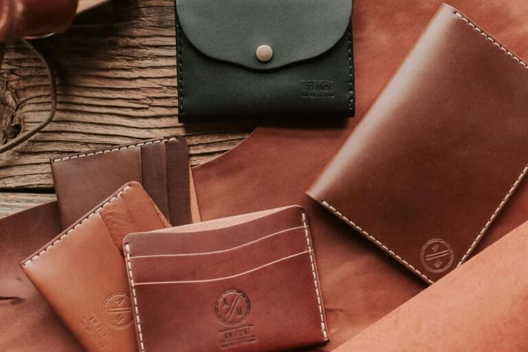 A collection of different custom men's leather wallets is shown in the image