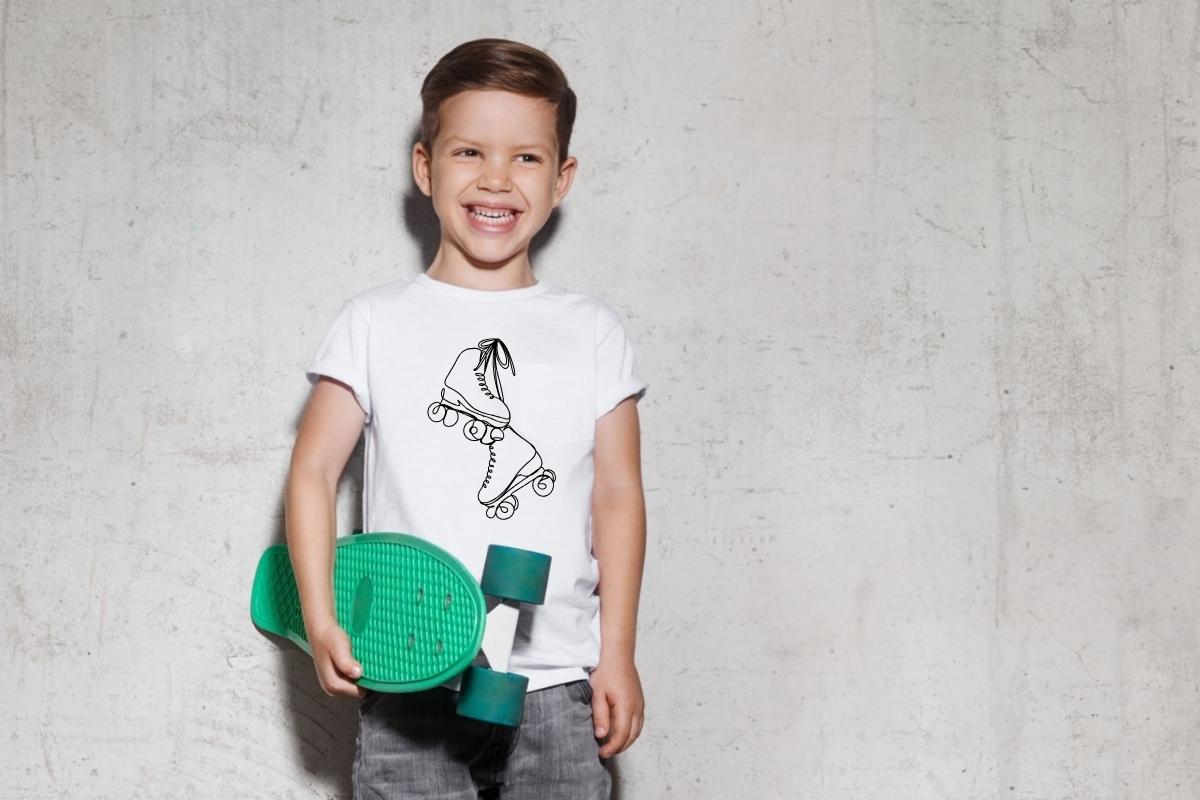 A kid wearing a T-shirt with a skating graphic on it