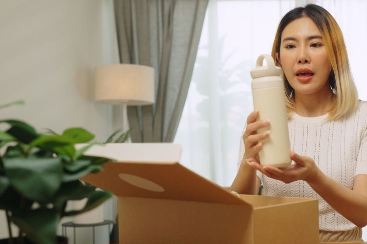 A lady inspecting her insulated water bottle that she bought online