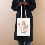 A lady is holding a grocery tote bag