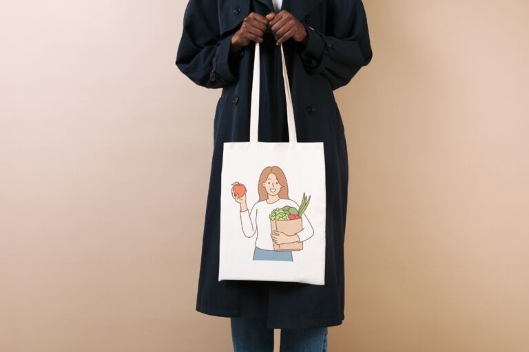A lady is holding a grocery tote bag