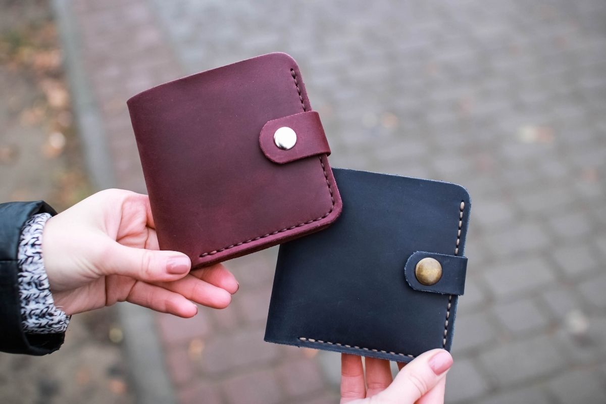 A lady presenting a curated selection of best-leather-wallets-men trust for timeless style