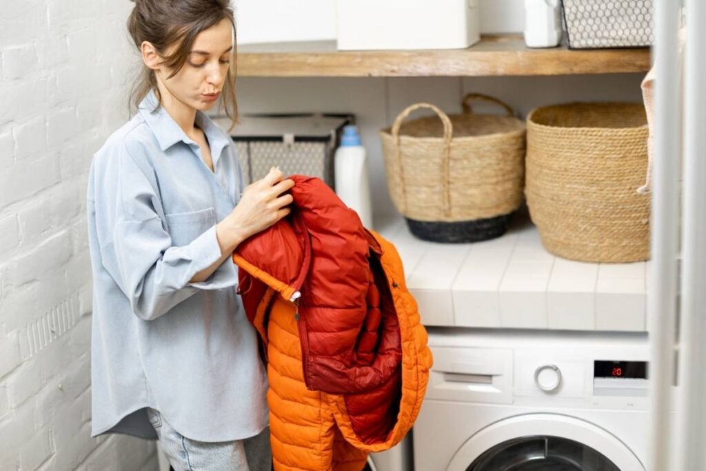 A lady reading the washing instructions on her boyfriend’s puffer jacket