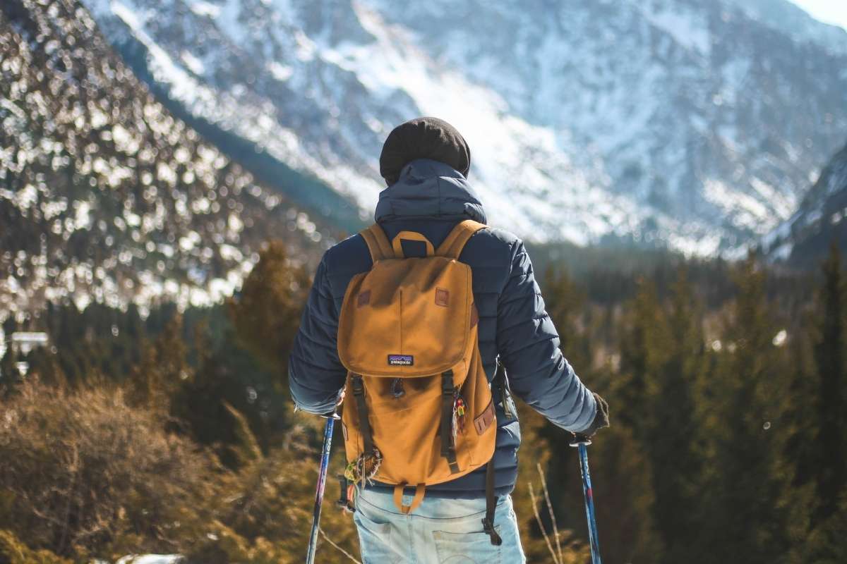 A person is using an eco canvas backpack for trekking