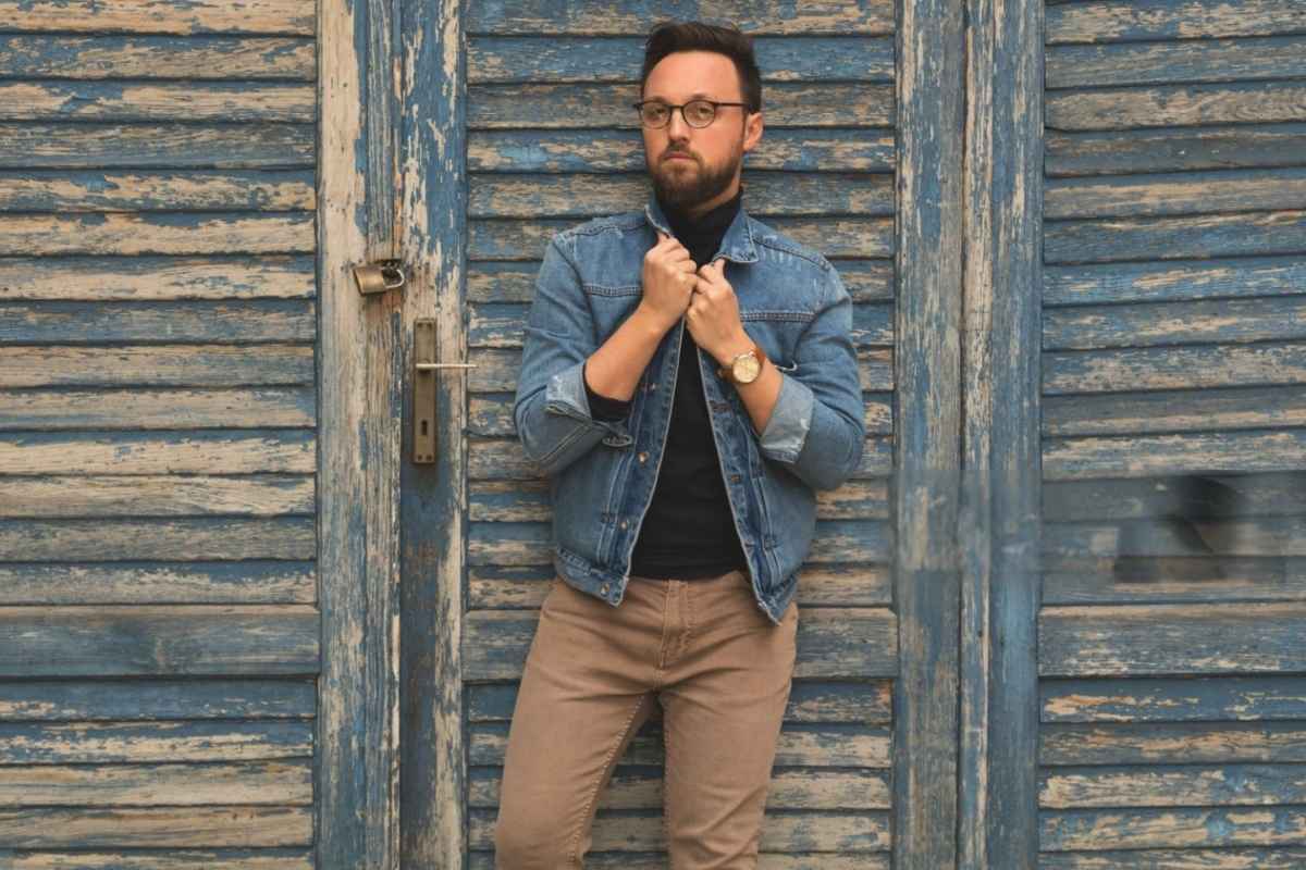 A person wearing a denim jacket with a preferred outfit