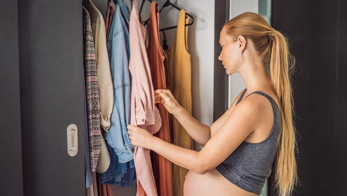A pregnant woman choosing best maternity summer outfits
