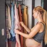 A pregnant woman choosing best maternity summer outfits