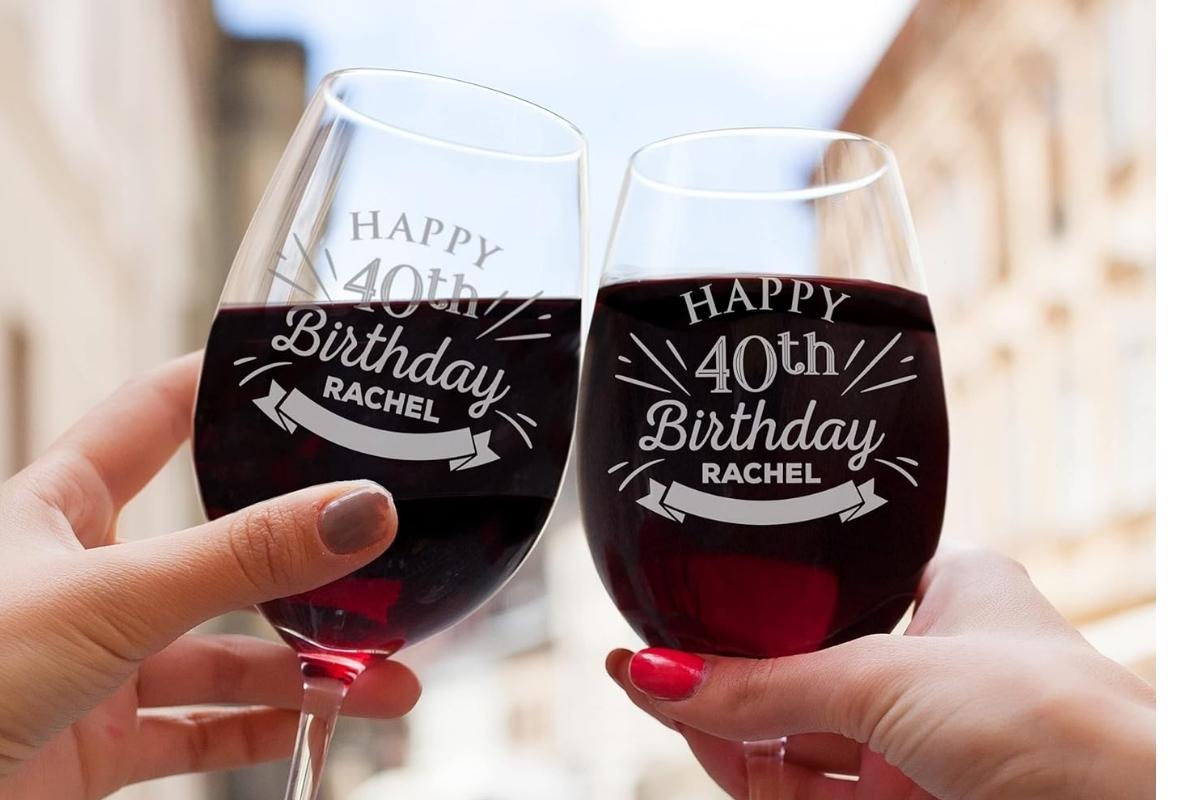 Friends celebrating a birthday with personalized wine glasses