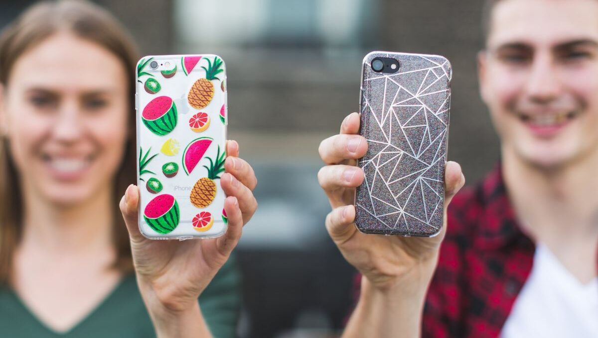 Two friends showing their personalized phone cases