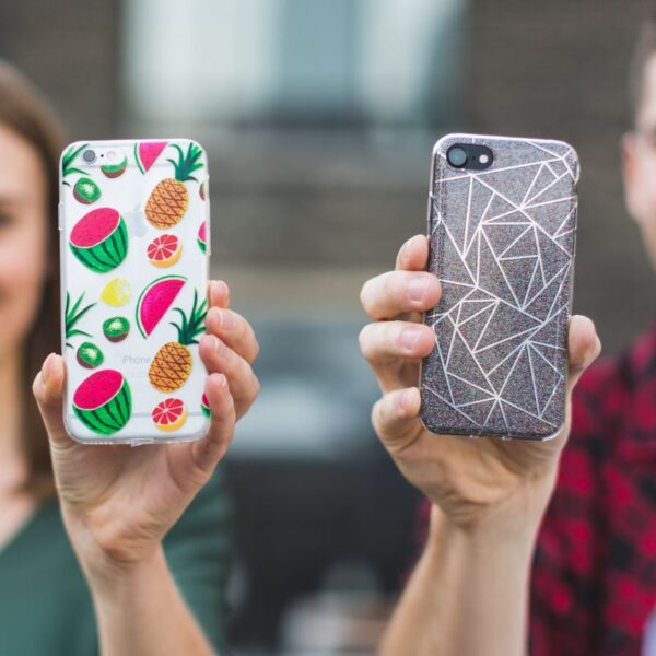 Two friends showing their personalized phone cases