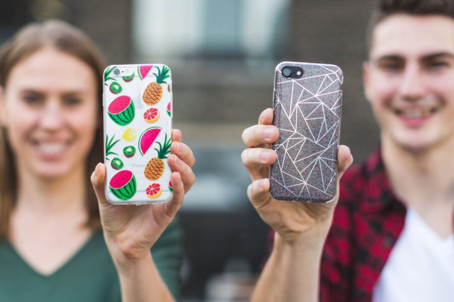 Two friends showing their personalized phone cases