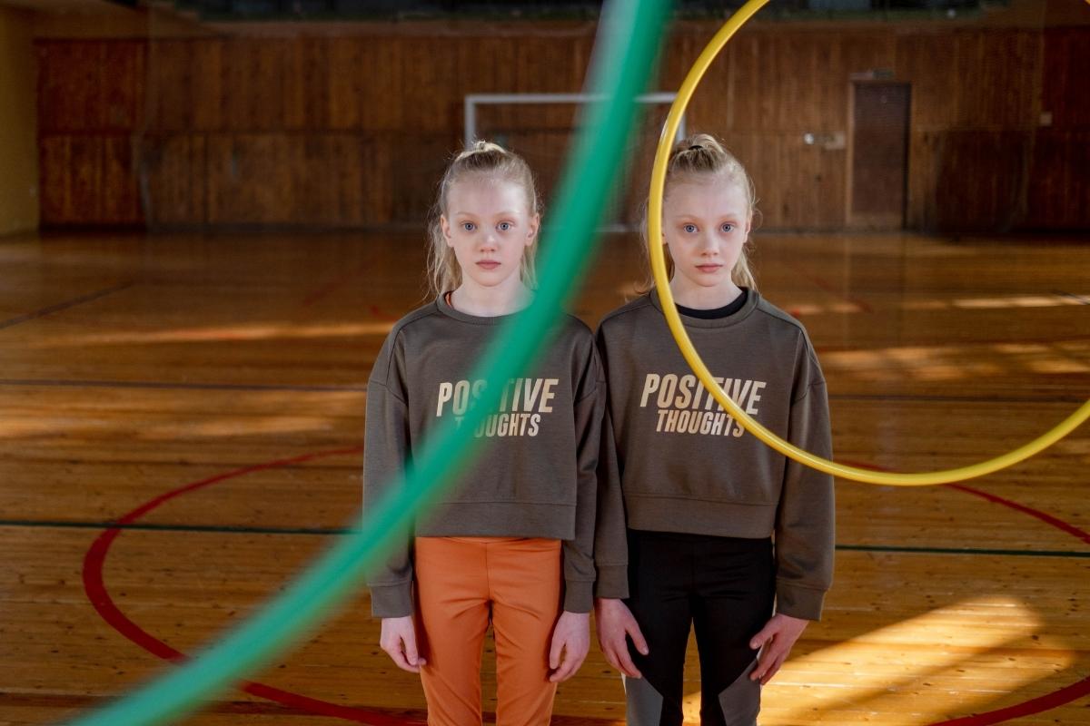Two girls wearing similar sweatshirts